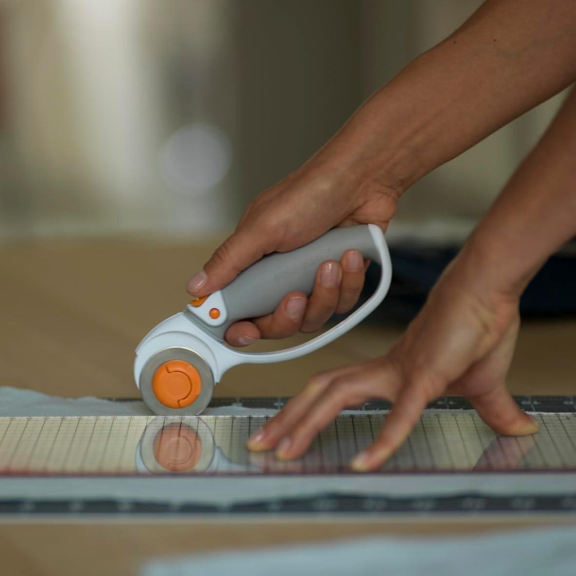 imageFiskars 45mm Rotary Cutter for Fabric Premium Steel Stick Fabric Cutter Cuts Through Multiple Layers Right and Left Handed Easy and Safe Blade Change Arts and Crafts Sewing and Quilting ToolsTitanium
